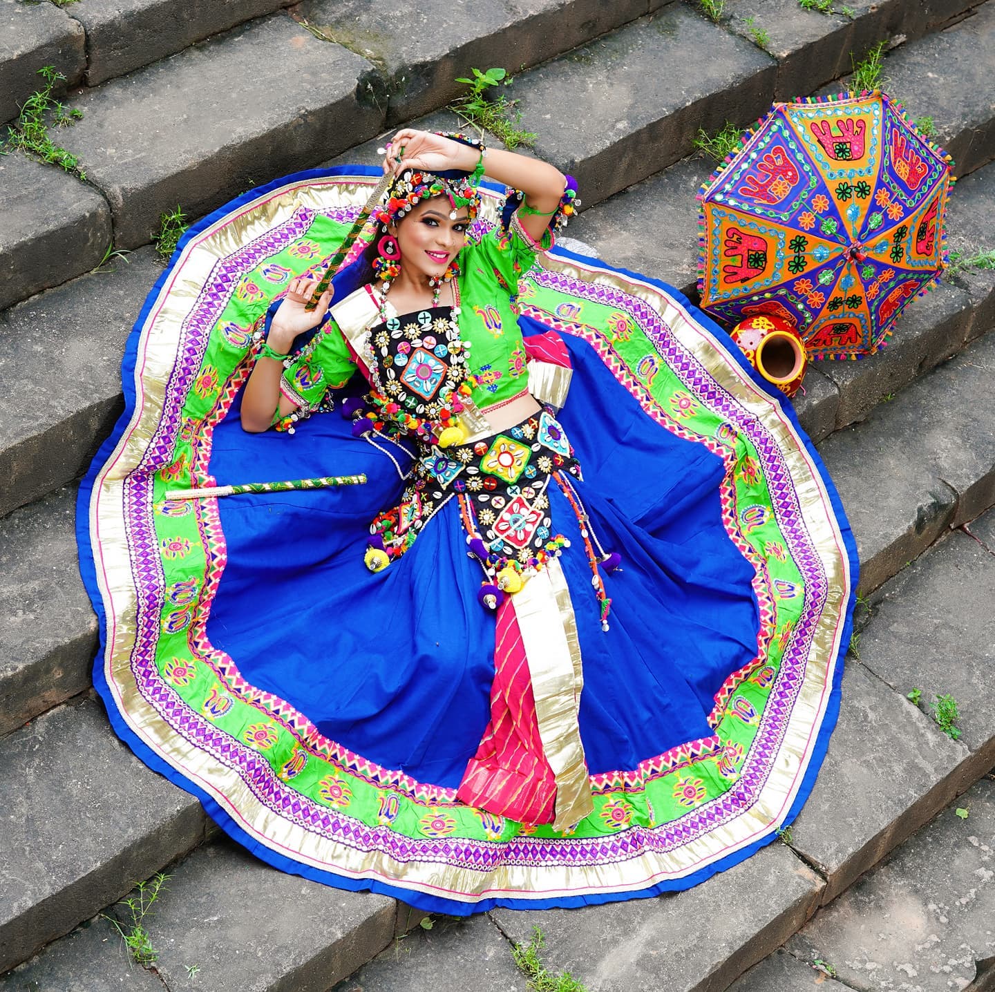 Girl sitting on stairs arial view wearing Navratri Jewelry