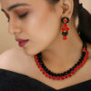 Beautiful girl wearing red and black necklace