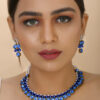 Girl wearing gorgeous blue choker necklace with earrings