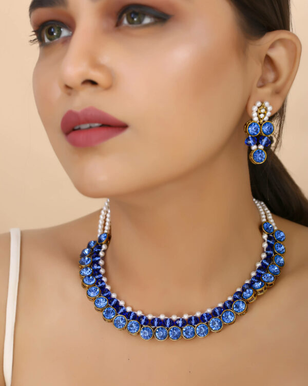 Girl wearing gorgeous blue choker necklace with earrings