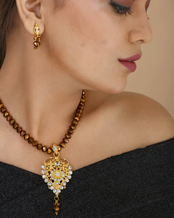 Girl Wearing Brown Crystal Beads Gold Pendant Designer Necklace