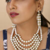 Girl Wearing Off-White Pearls Diamond Rings Multi Row Necklace